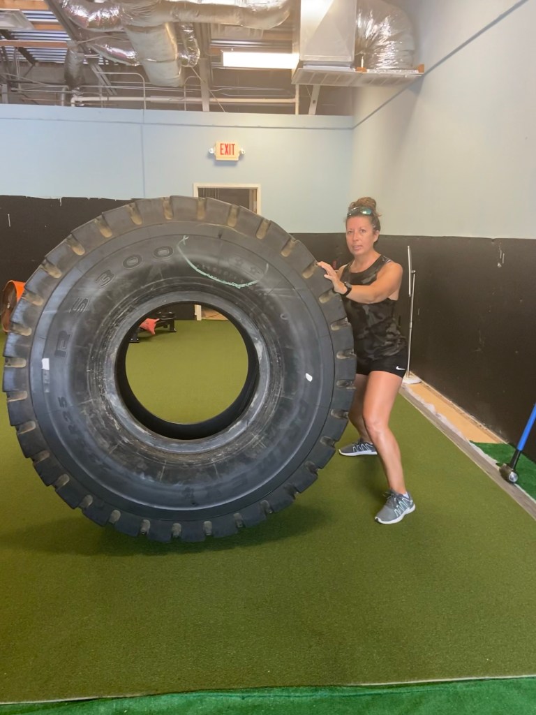 Me holding up a giant tire.