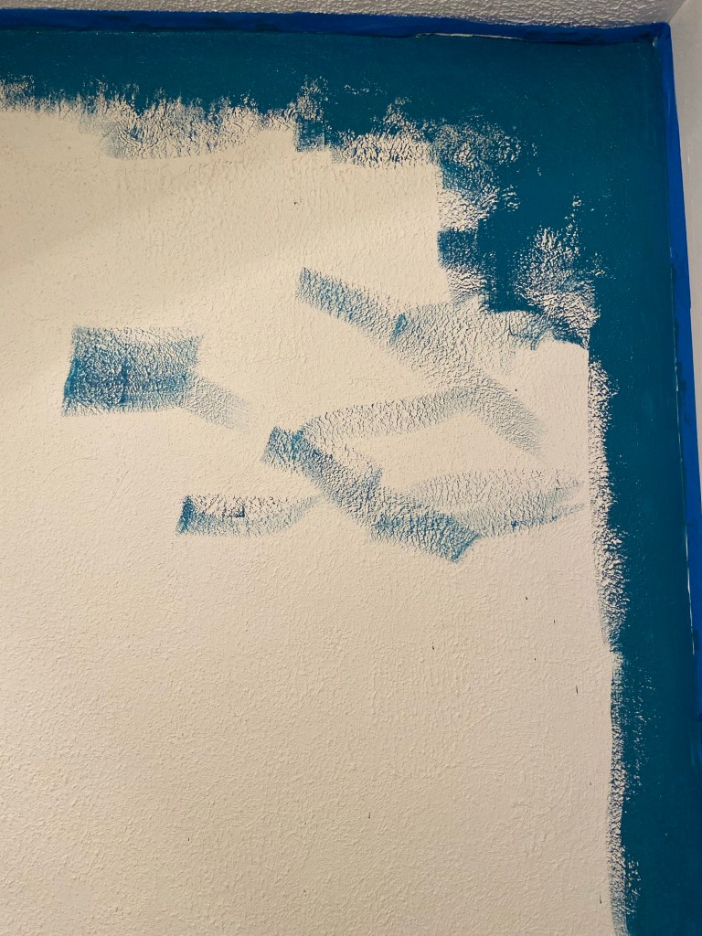 Deep teal partially painted wall