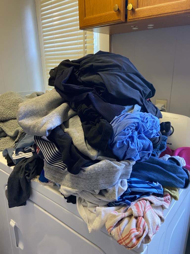 Pile of laundry on top of dryer